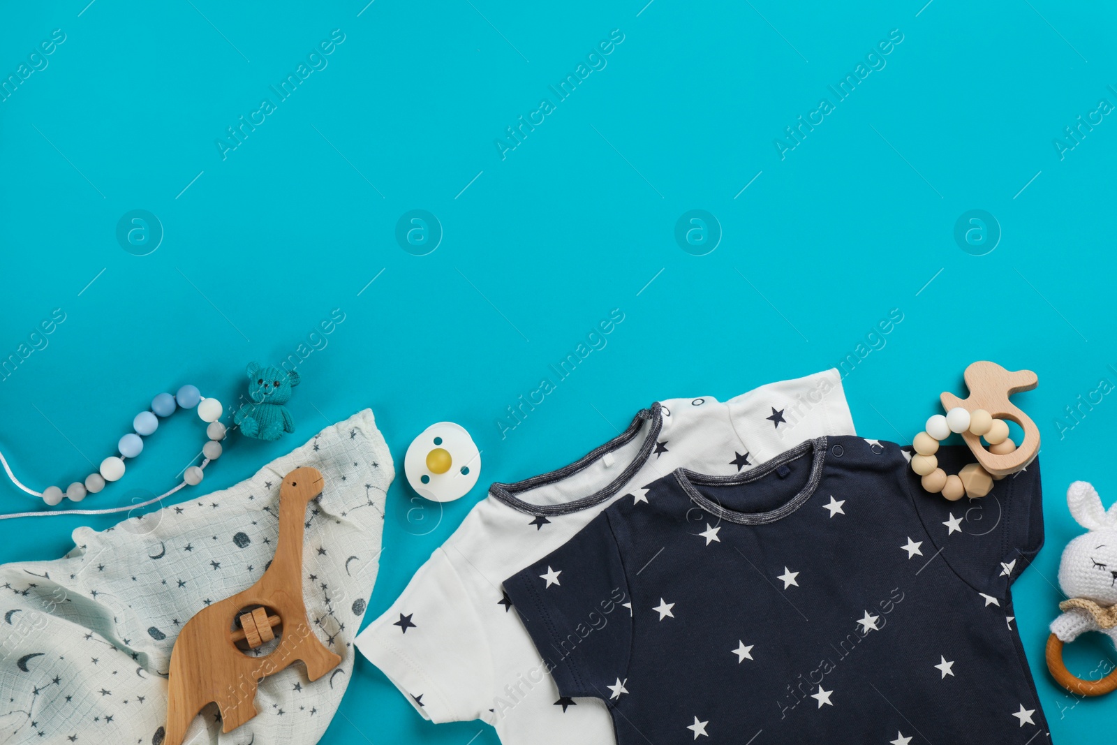 Photo of Flat lay composition with baby clothes and accessories on light blue background, space for text