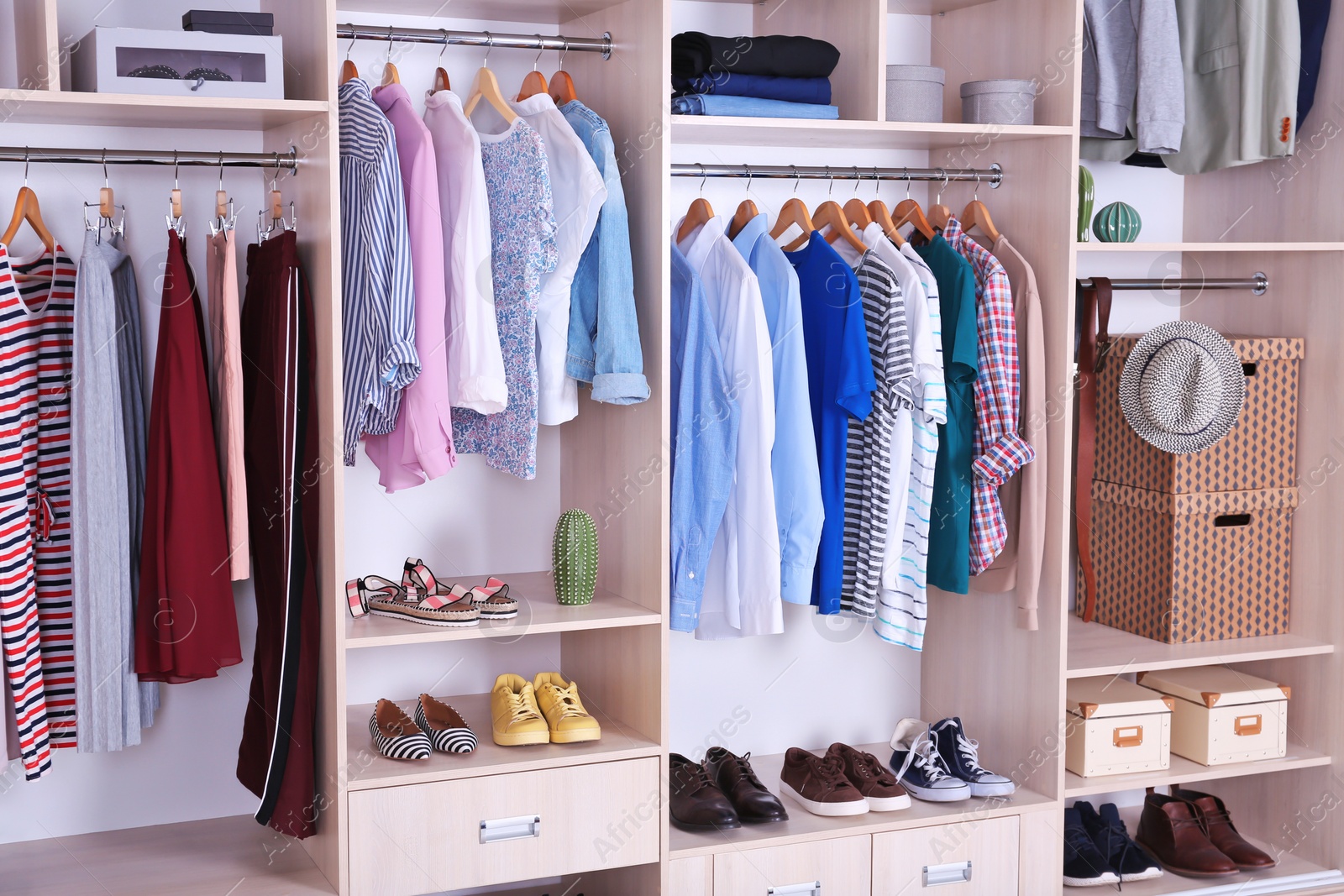 Photo of Large wardrobe with different clothes and shoes