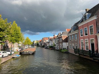 Photo of Beautiful view of buildings near canal in city under cloudy sky