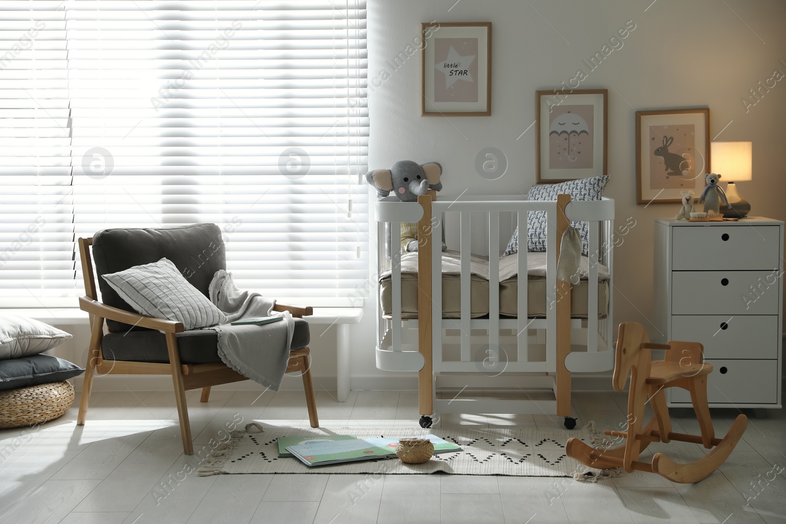 Photo of Baby room interior with crib, armchair and rocking horse. Idea for design