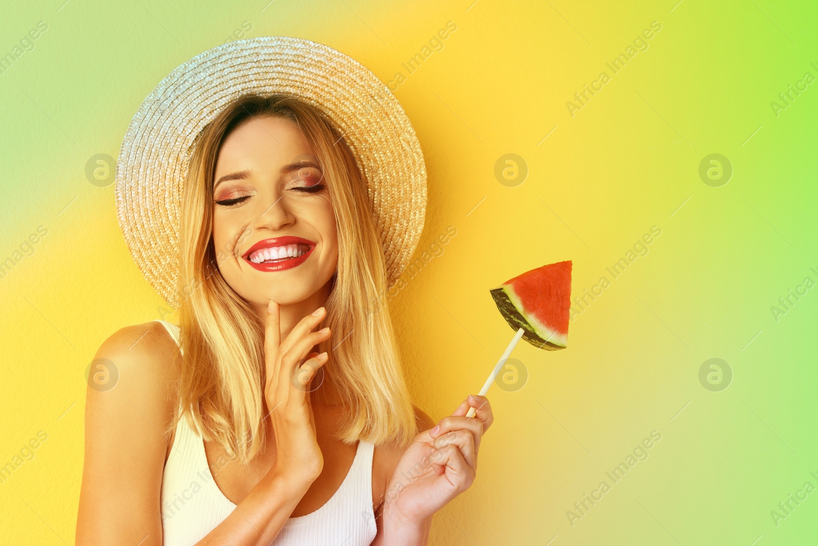 Image of Pretty young woman with juicy watermelon on color background. Summer party