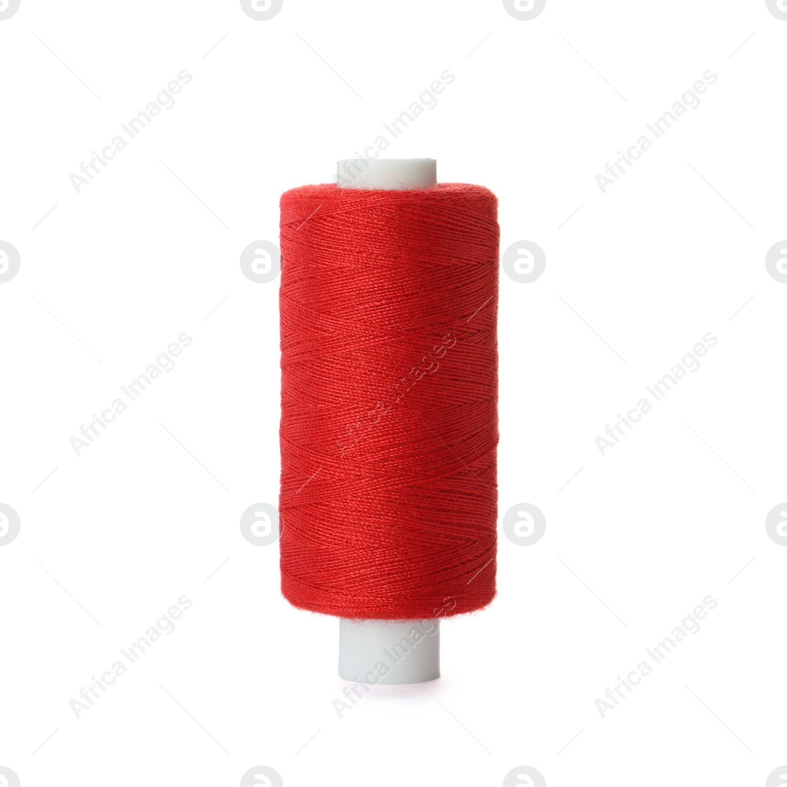 Photo of Spool of red sewing thread isolated on white