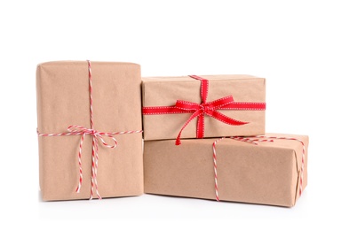 Photo of Beautifully wrapped gift boxes on white background