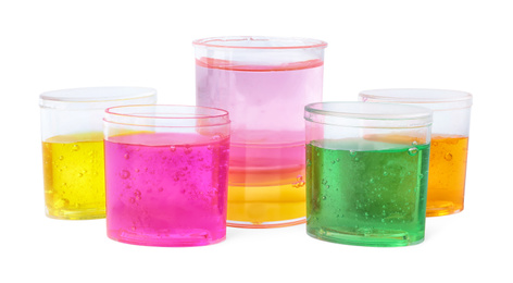 Photo of Colorful slimes in plastic containers isolated on white. Antistress toy