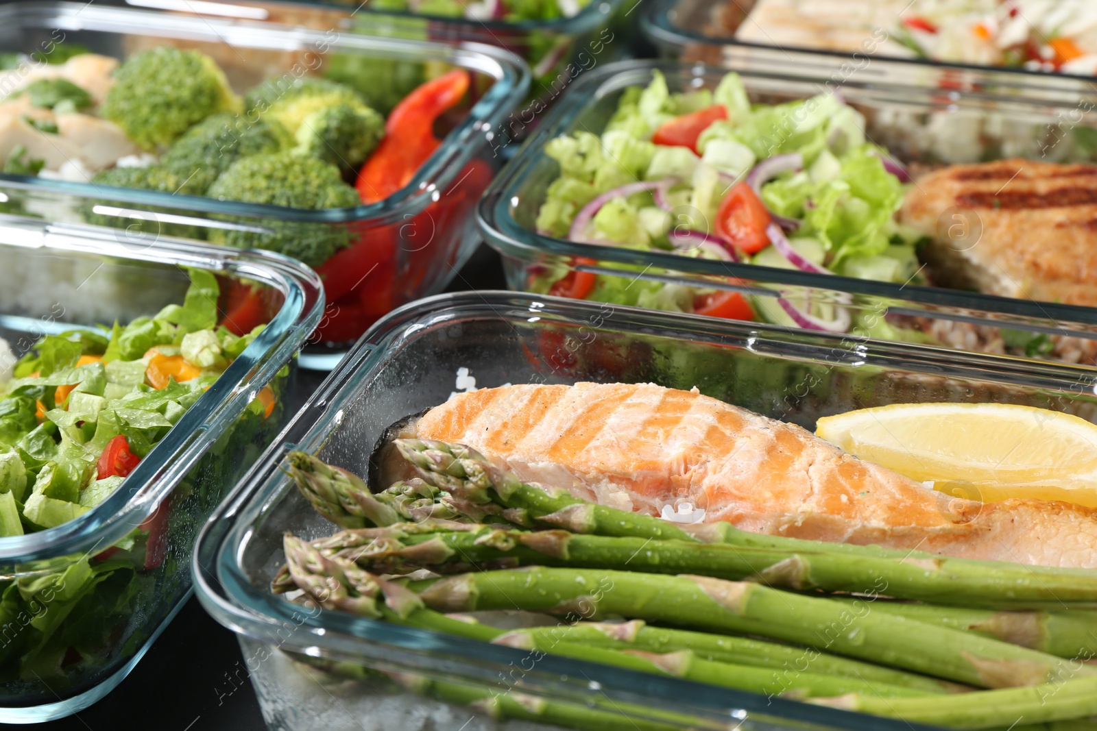 Photo of Healthy food. Different meals in glass containers on table, closeup