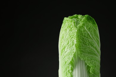 Photo of Fresh ripe Chinese cabbage on black background, space for text