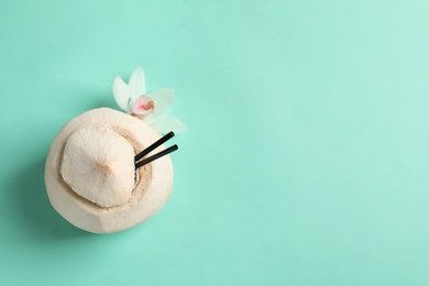 Photo of Fresh coconut drink in nut on color background