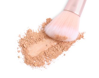 Loose face powder and makeup brush on white background, top view
