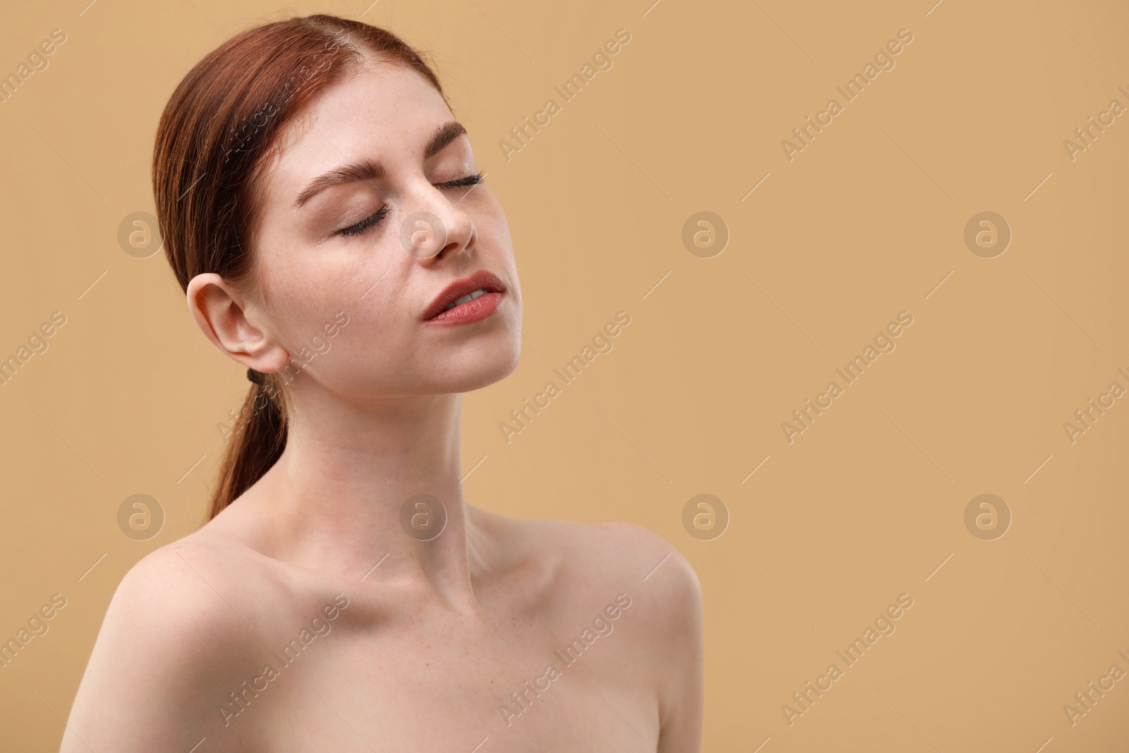 Photo of Portrait of beautiful woman on beige background. Space for text