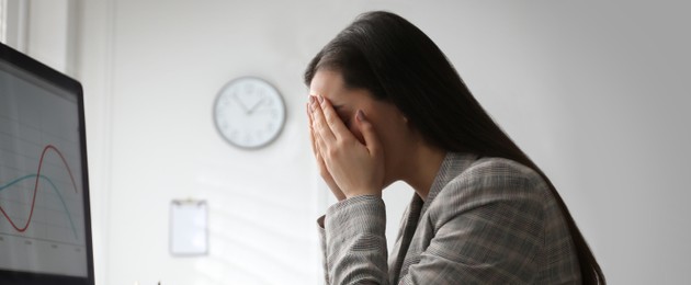 Tired young businesswoman at workplace in office. Banner design