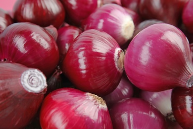 Ripe red onions as background