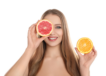 Young woman with cut orange and grapefruit on white background. Vitamin rich food