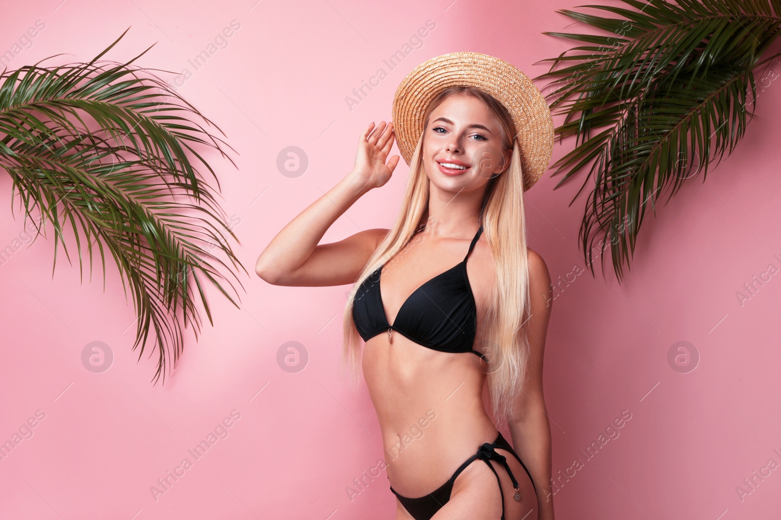 Photo of Pretty young woman wearing stylish bikini on pink background