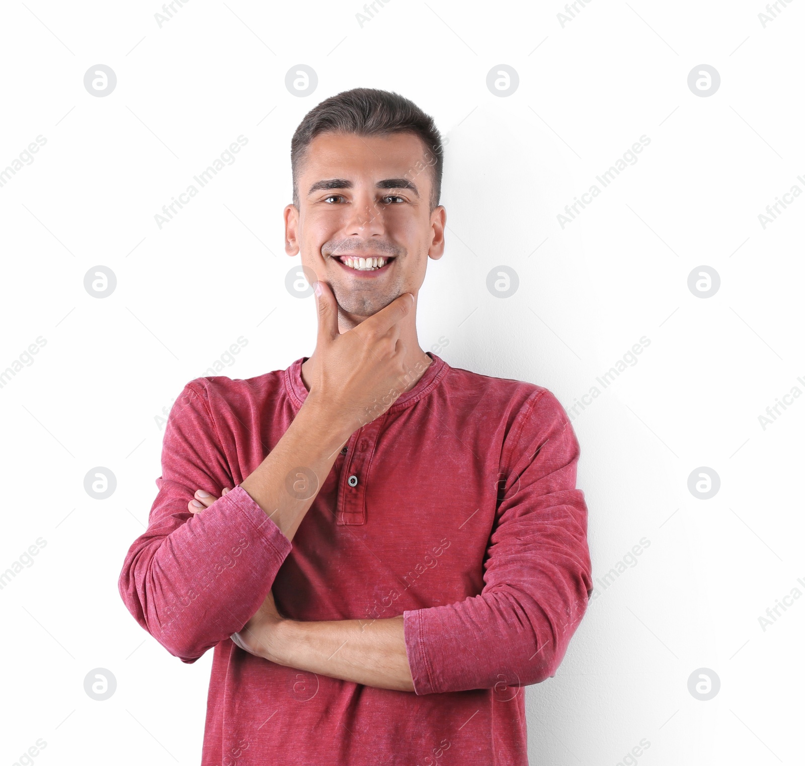 Photo of Handsome young man smiling on white background