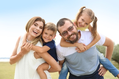 Photo of Happy family spending time together with their children outdoors