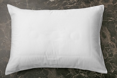 Soft bed pillow on dark background, top view