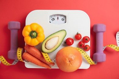 Photo of Flat lay composition with scales and healthy food on red background