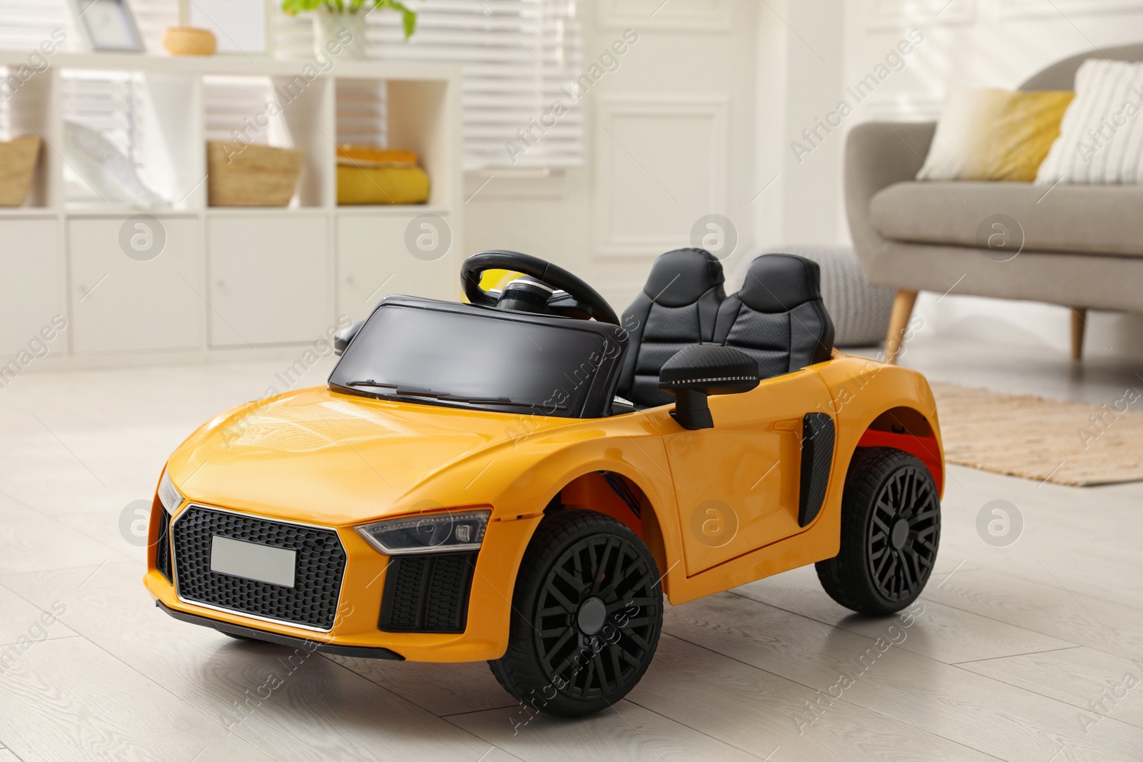 Photo of New yellow toy car in living room