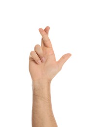 Photo of Man with crossed fingers on white background, closeup. Superstition concept