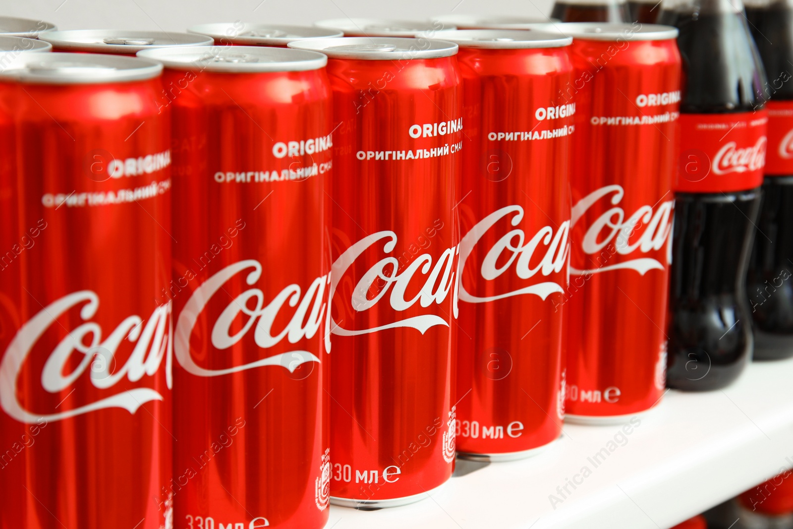 Photo of MYKOLAIV, UKRAINE - NOVEMBER 14, 2018: Many Coca-Cola cans on display in store