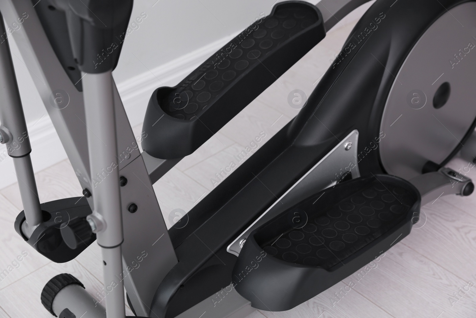 Photo of Modern elliptical machine cross trainer on floor indoors