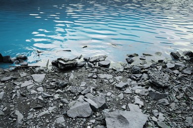 View of beautiful lake with rocky shore