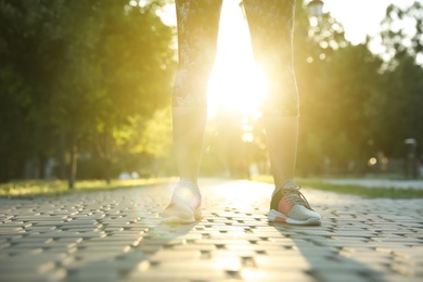 Woman in sportswear outdoors, closeup. Morning exercise