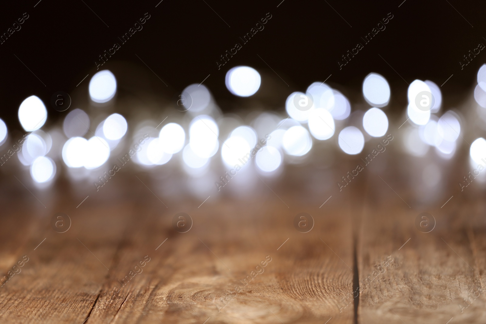 Photo of Blurred view of festive lights on dark background. Bokeh effect
