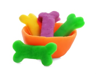 Bowl with bones made from play dough on white background