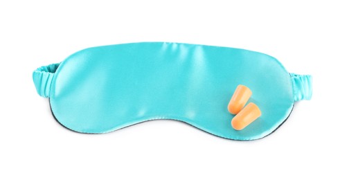 Photo of Pair of ear plugs and light blue sleeping mask on white background