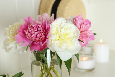 Bouquet of beautiful peonies in vase indoors, closeup