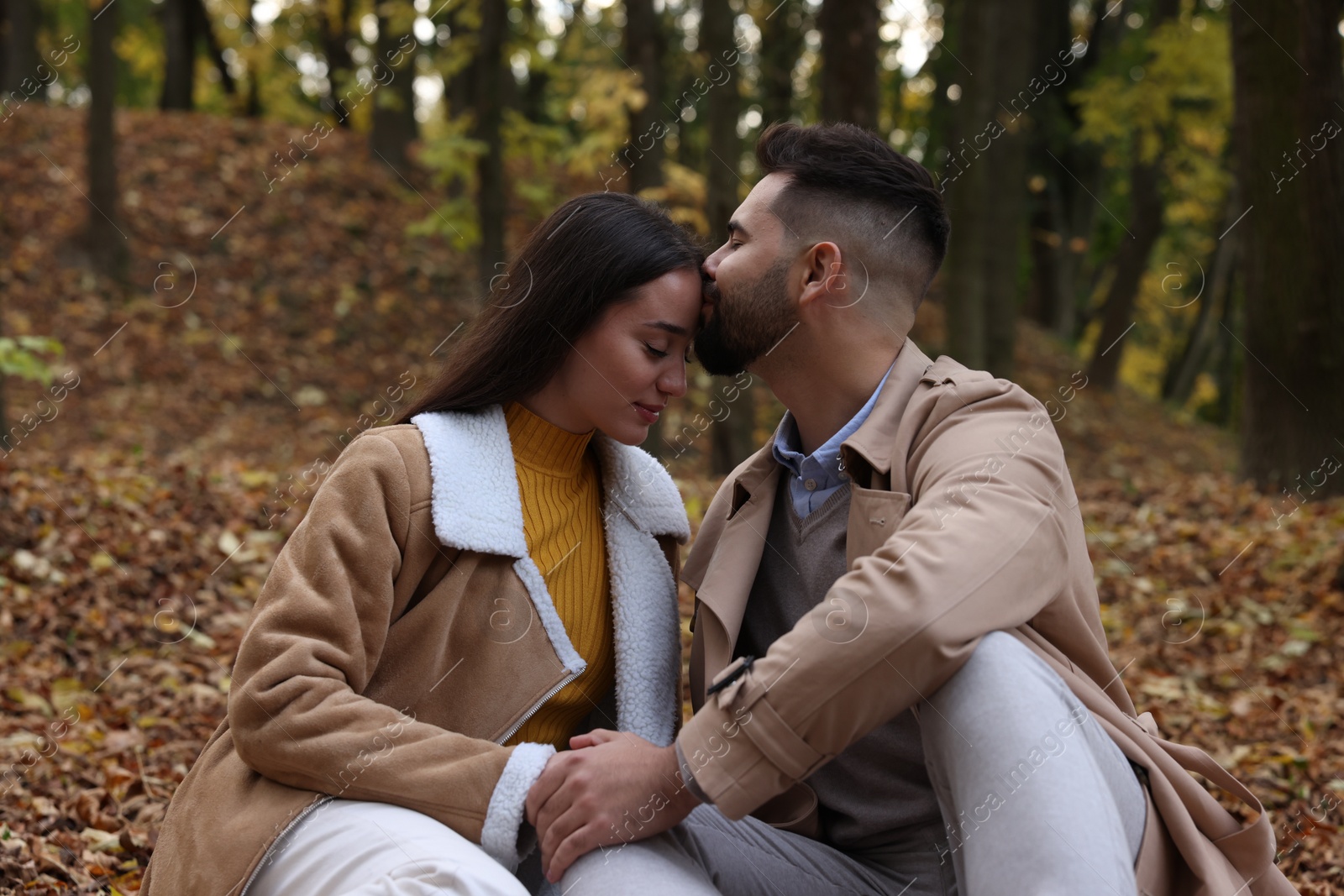 Photo of Happy young couple spending time together in autumn park