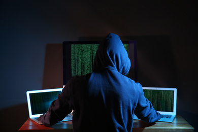 Hacker with computers in dark room. Cyber crime