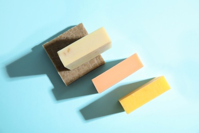 Hand made soap bars on color background, top view