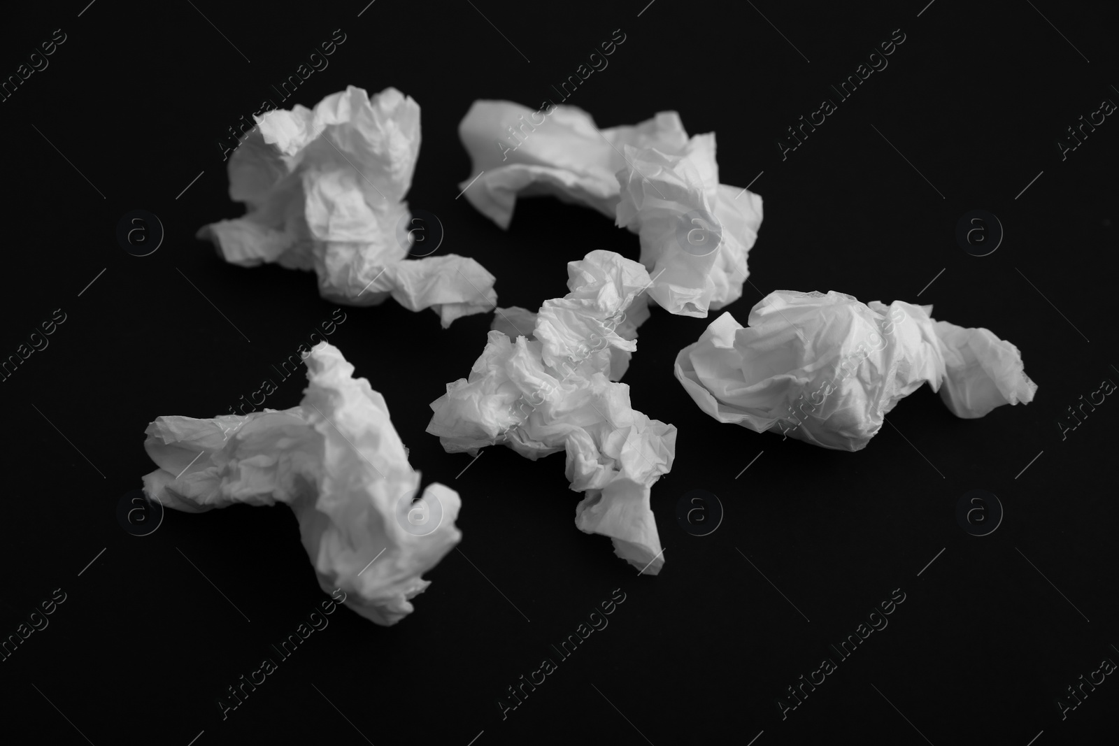 Photo of Used white paper tissues on black background