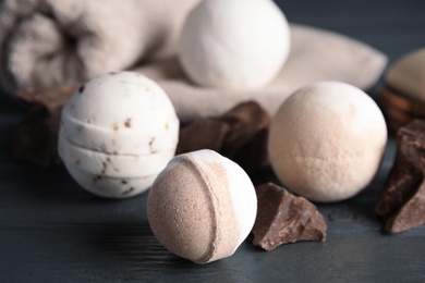 Photo of Bath bombs with pieces of chocolate on table