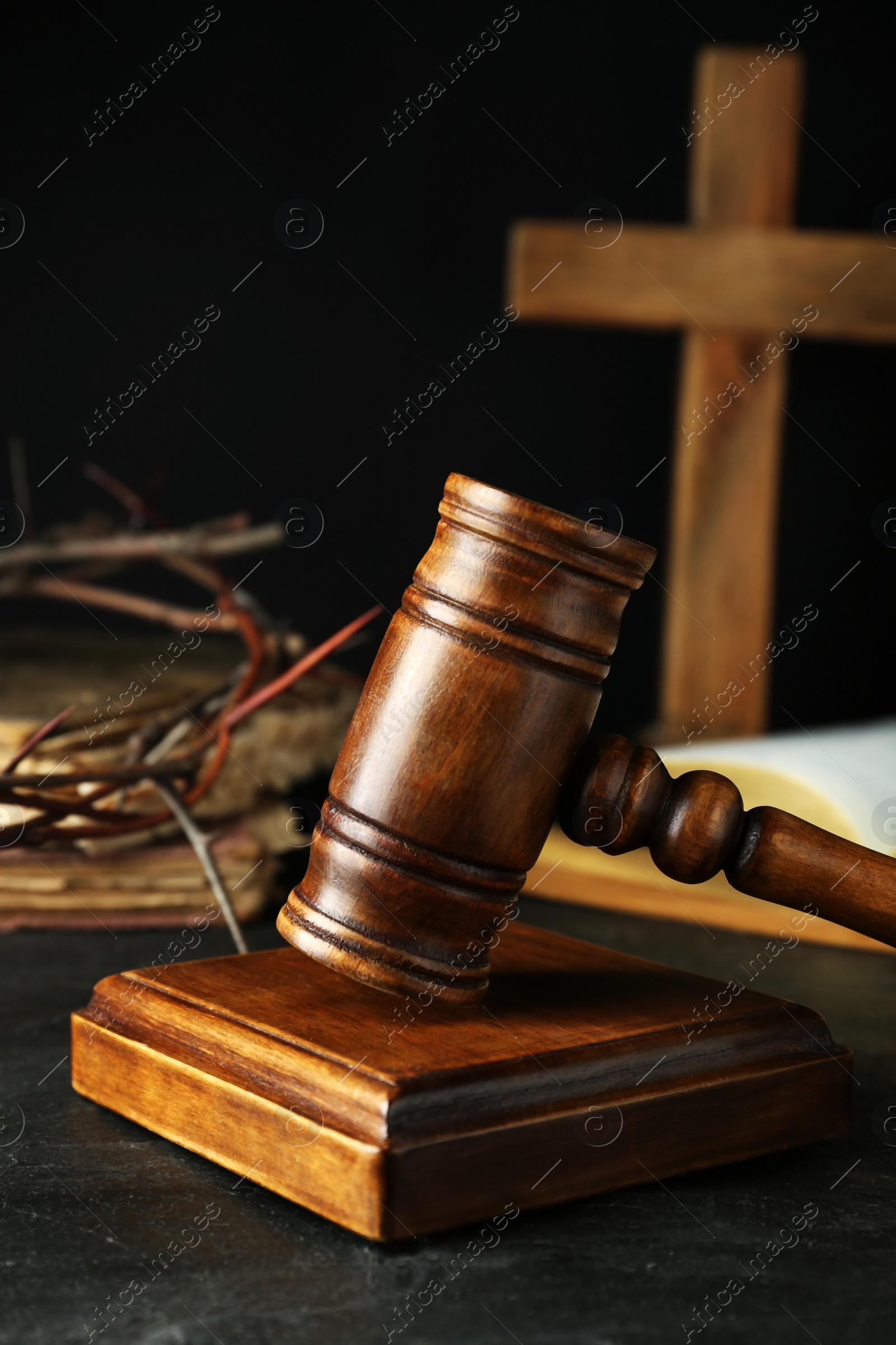 Photo of Wooden judge gavel on table against black background