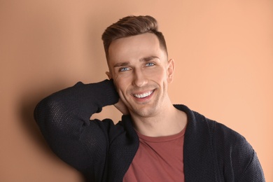 Photo of Portrait of young man with beautiful hair on color background