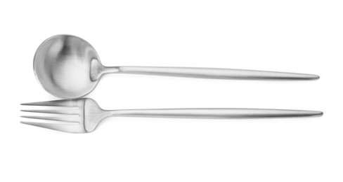 Photo of Shiny silver fork and spoon isolated on white, top view. Luxury cutlery