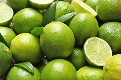 Fresh ripe green limes as background