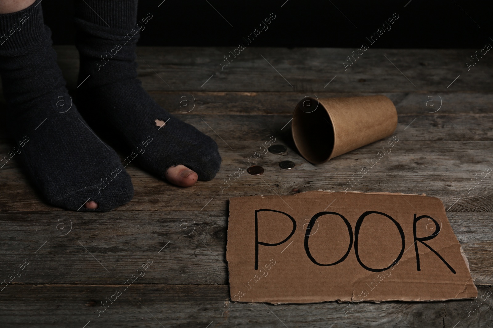 Photo of Poor person in shabby socks begging for money, closeup