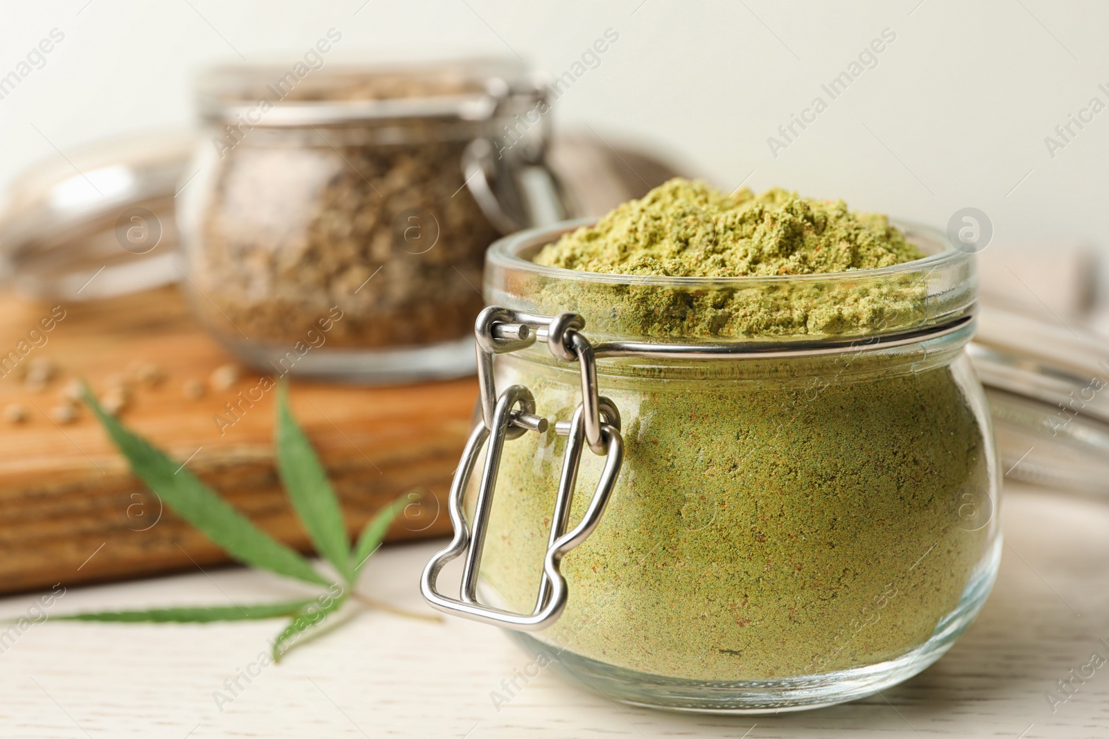 Photo of Jar of hemp protein powder on light table, closeup