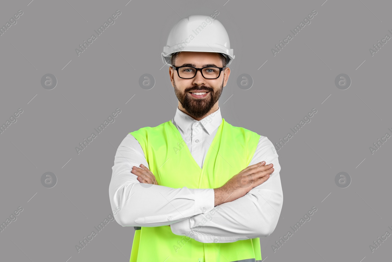 Photo of Engineer in hard hat on grey background