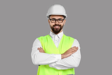 Engineer in hard hat on grey background