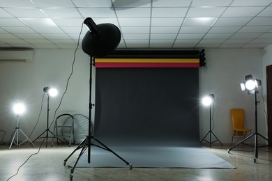 Interior of modern photo studio with professional lighting equipment