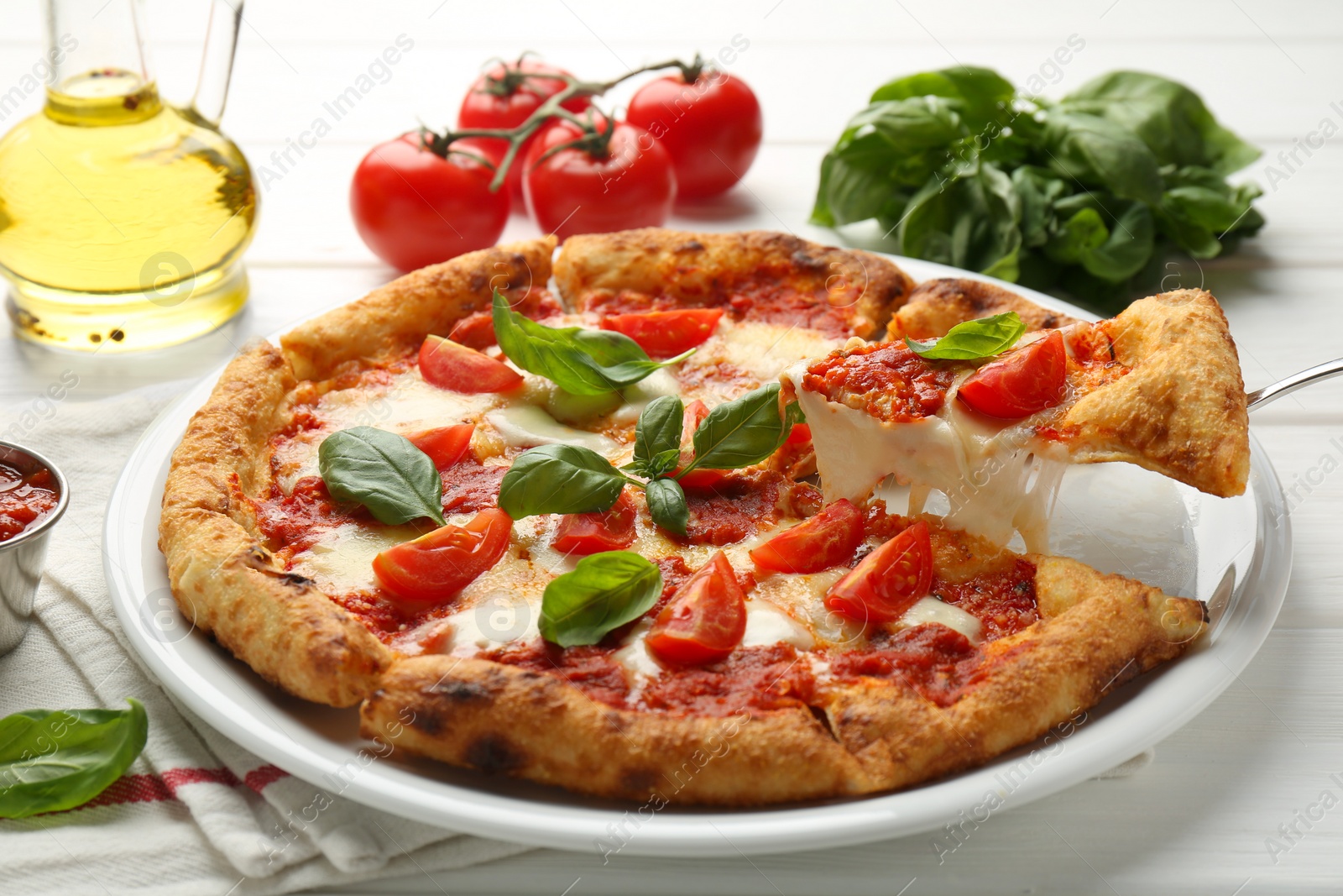 Photo of Taking piece of delicious Margherita pizza at white table, closeup