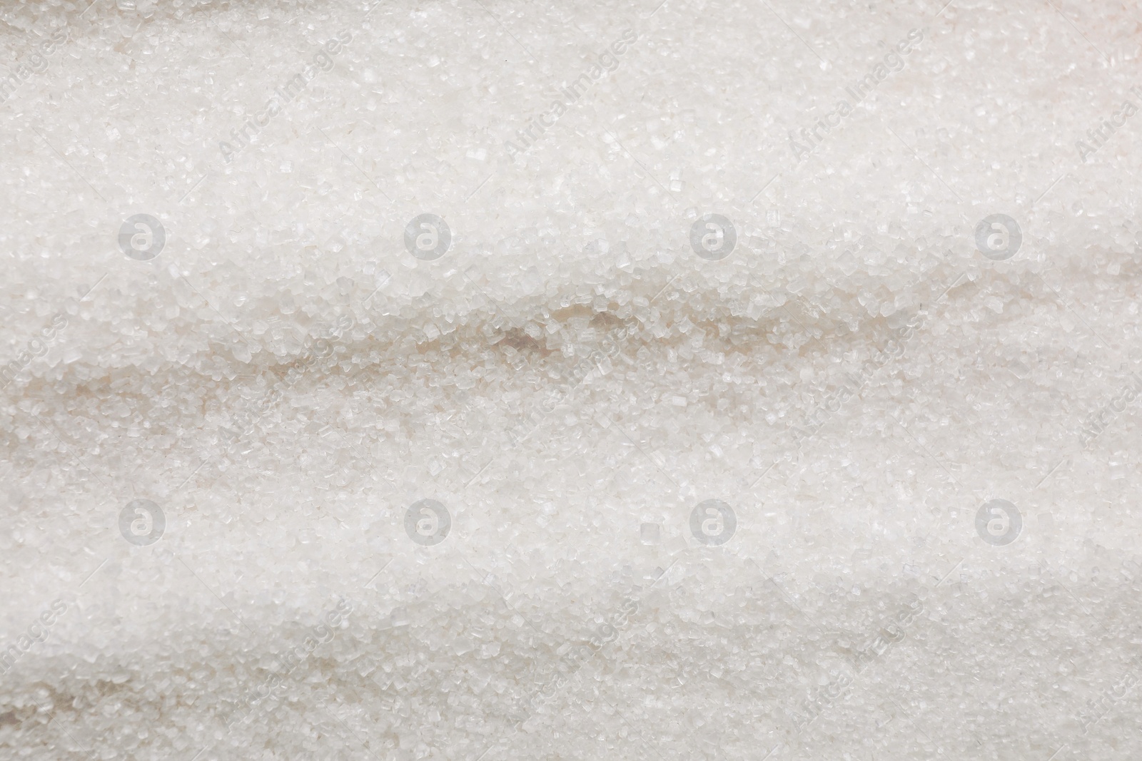 Photo of Granulated white sugar as background, top view