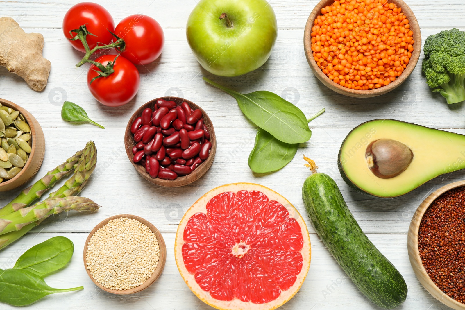 Photo of Different vegetables, seeds and fruits on white wooden table, flat lay. Healthy diet