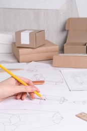 Woman creating packaging design at table, closeup