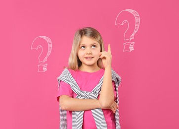 Image of Choice in profession or other areas of life, concept. Making decision, cute little girl surrounded by drawn question marks on pink background
